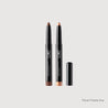 Two makeup pencils with black casings and brown tips on a light gray background.