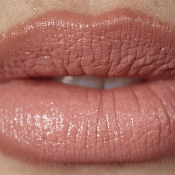 Close-up of a person's lips with a glossy lip color