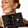 Woman holding a makeup set with lipsticks in a case