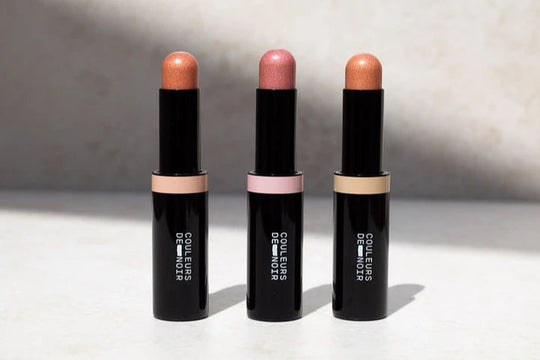 Three black highlighters with visible color swatches on a light background